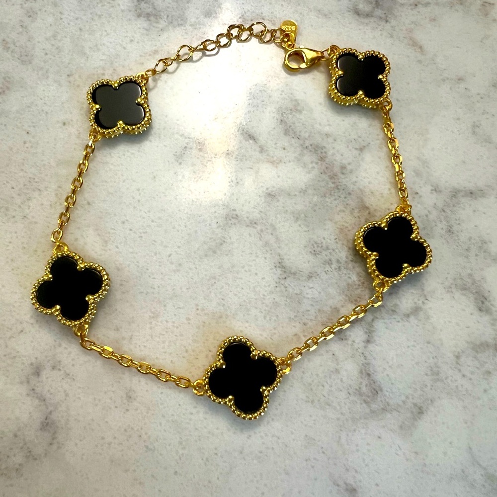 New without tags sterling silver gold-plated black onyx, clover bracelet.